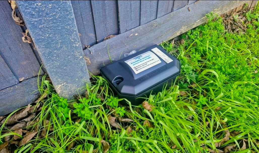 Discreet external rodent bait station installed at a property